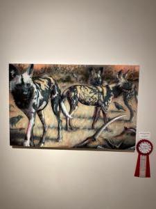 "Wild Dogs with Antelope" oil. Lynette K. Henderson. Second Place